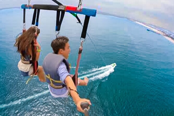 Parasailing above Turquoise Ocean Waters in Montego Bay - Taking off above Montego Bay’s turquoise water